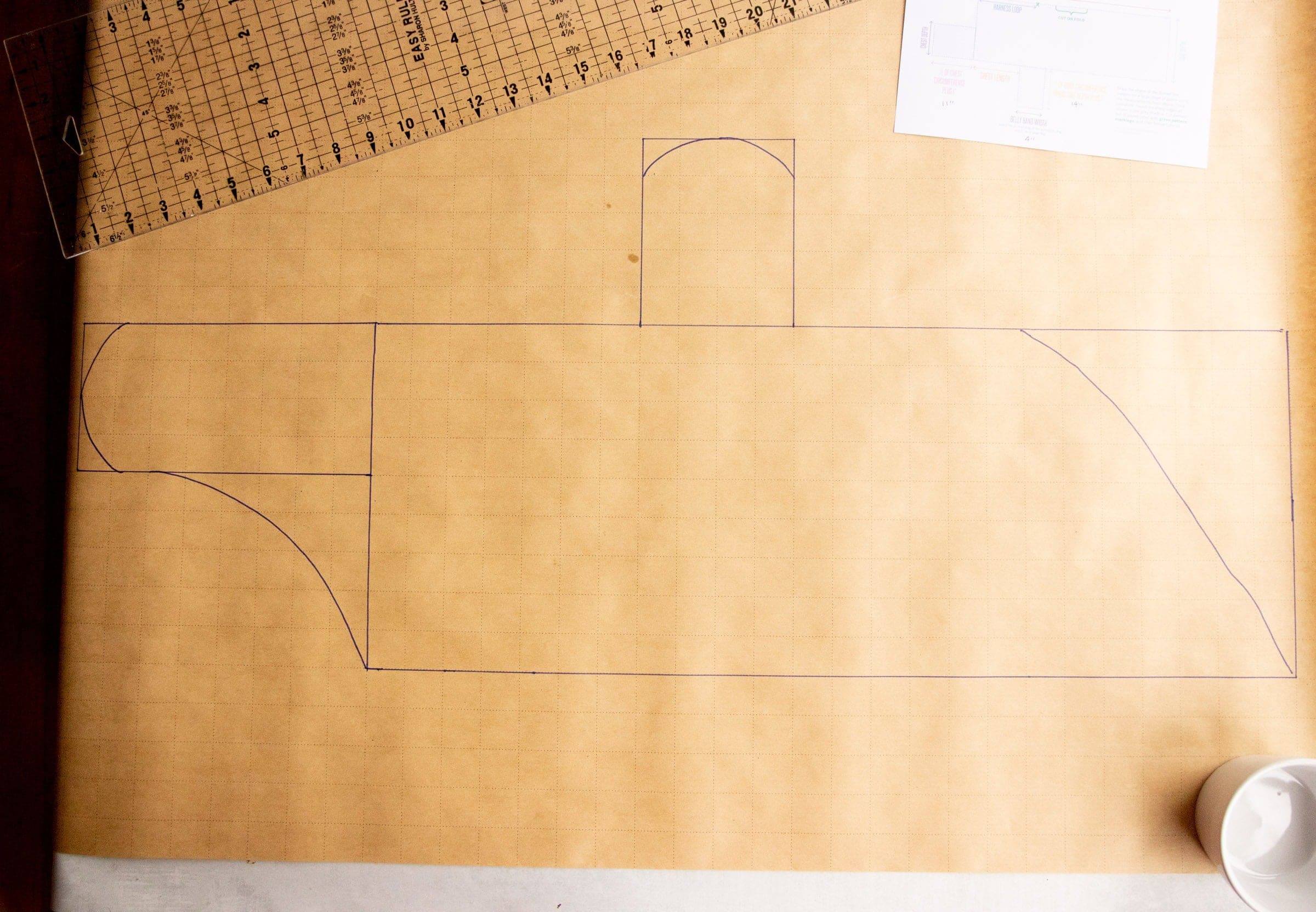 Pattern for a dog coat on pattern paper, with the edges of the pattern curved